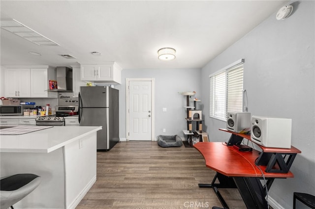 2004 Palm Ave, Highland, CA 92346 - kitchen with stainless steel appliances, wall chimney range hood, wood finished floors, white cabinetry, and light countertops