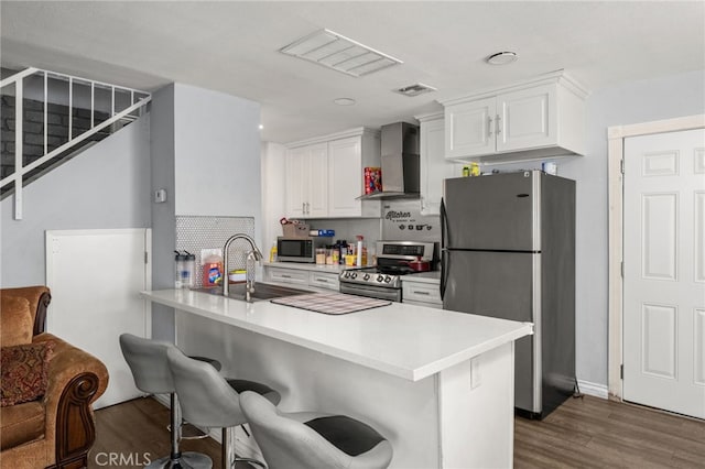 2004 Palm Ave, Highland, CA 92346 - kitchen with wall chimney range hood, stainless steel appliances, a sink, and dark wood-style floors