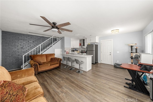 2004 Palm Ave, Highland, CA 92346 - living room featuring ceiling fan, wood finished floors, and stairway