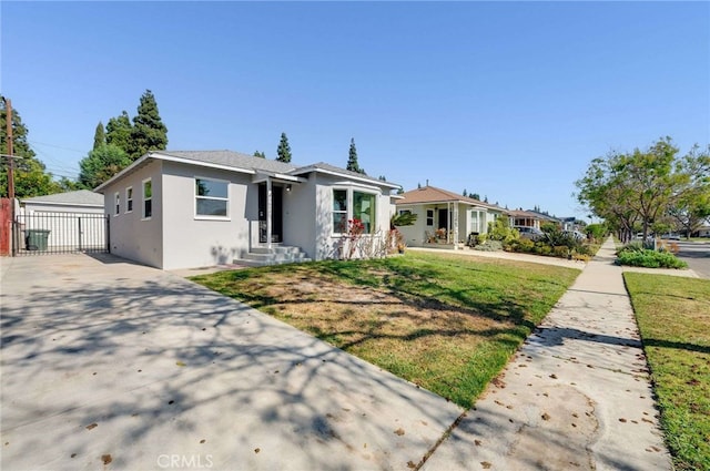 5642 Briercrest Ave, Lakewood, CA 90713 - bungalow featuring stucco siding, driveway, a front lawn, and an outdoor structure