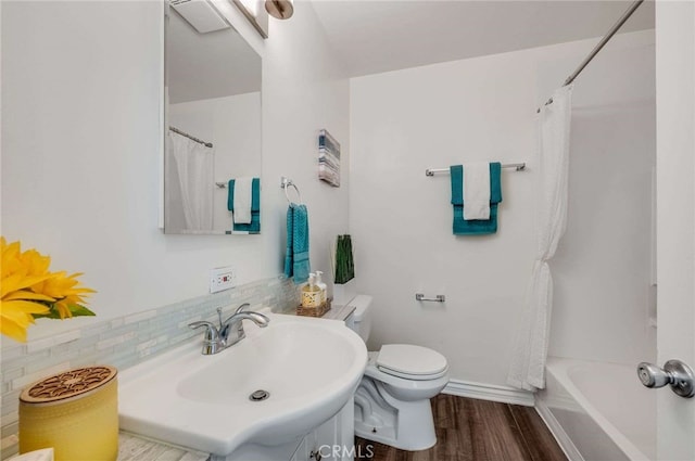 5642 Briercrest Ave, Lakewood, CA 90713 - bathroom featuring toilet, wood finished floors, vanity, baseboards, and shower / bath combination with curtain