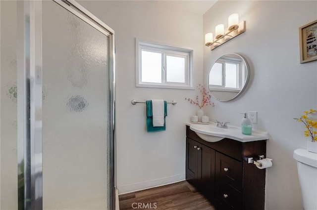 5642 Briercrest Ave, Lakewood, CA 90713 - full bathroom featuring a shower stall, toilet, vanity, and wood finished floors