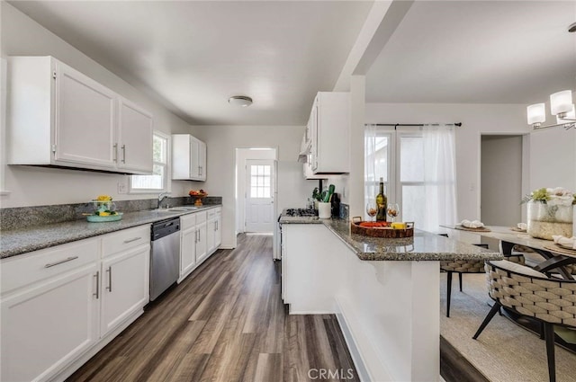 5642 Briercrest Ave, Lakewood, CA 90713 - kitchen with stainless steel dishwasher, a peninsula, white cabinets, dark wood-style flooring, and a breakfast bar area