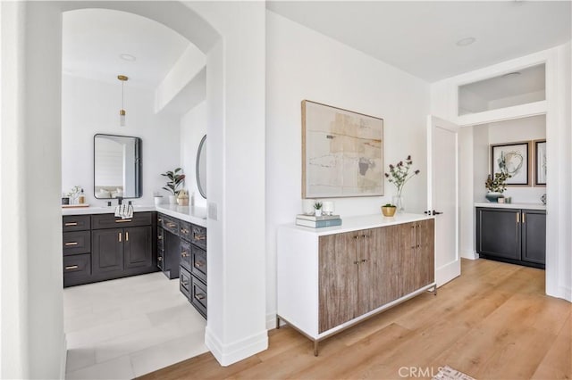 17 Candlewood, Irvine, CA 92620 - full bathroom featuring two vanities, wood finished floors, and baseboards