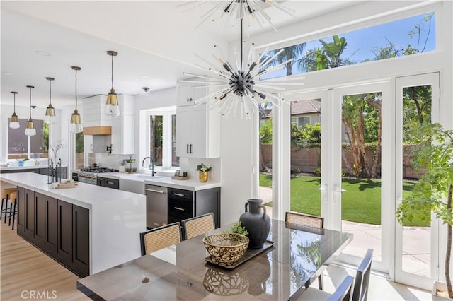 17 Candlewood, Irvine, CA 92620 - dining room featuring a chandelier, french doors, and light wood-type flooring