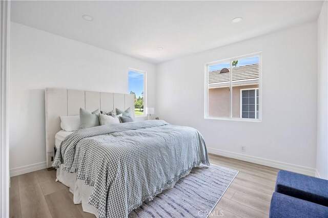 17 Candlewood, Irvine, CA 92620 - bedroom with multiple windows, baseboards, light wood-style flooring, and recessed lighting