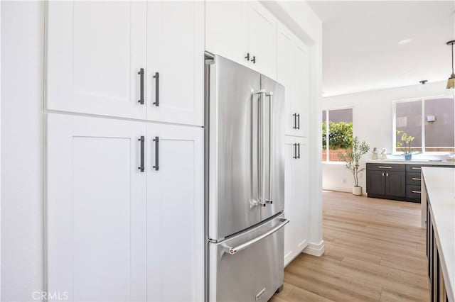 17 Candlewood, Irvine, CA 92620 - kitchen with high end refrigerator, white cabinetry, and light wood finished floors