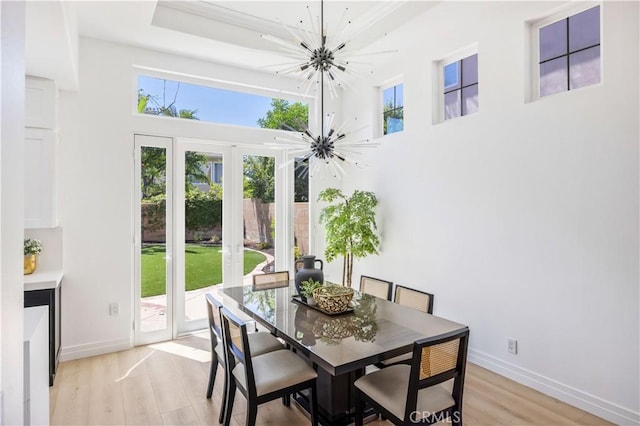 17 Candlewood, Irvine, CA 92620 - dining space with a chandelier, french doors, a high ceiling, light wood finished floors, and baseboards