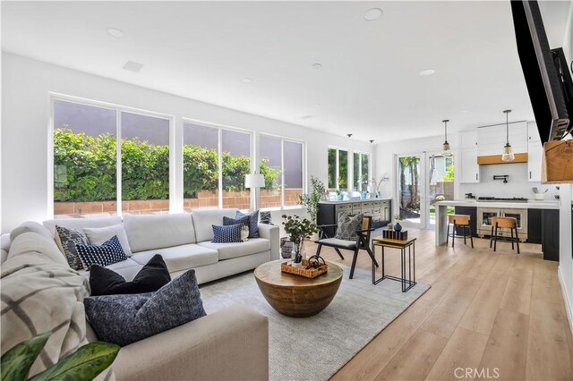 17 Candlewood, Irvine, CA 92620 - living room featuring light wood-style flooring and recessed lighting