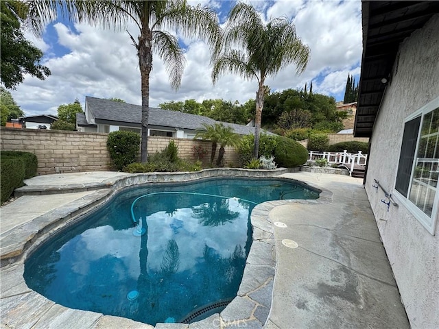 view of swimming pool with a fenced backyard and a patio area