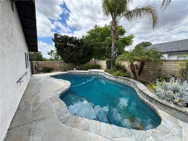 view of swimming pool with a fenced backyard and a patio