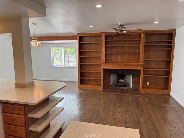 living area featuring dark wood finished floors, baseboards, recessed lighting, ceiling fan, and a brick fireplace