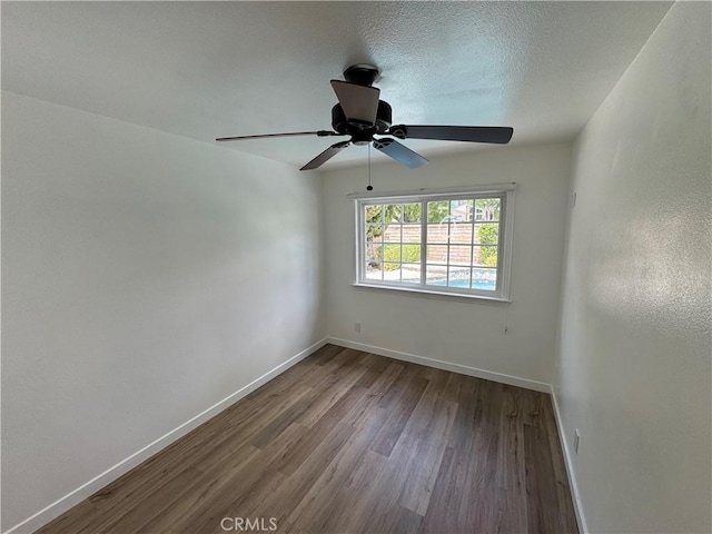unfurnished room featuring baseboards and wood finished floors