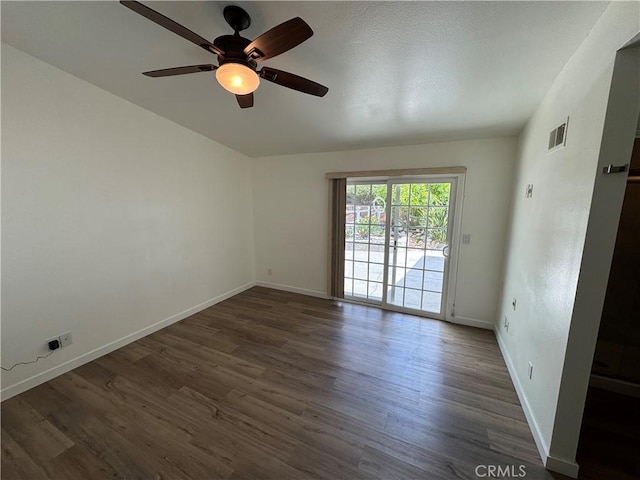 spare room with wood finished floors, baseboards, and a ceiling fan