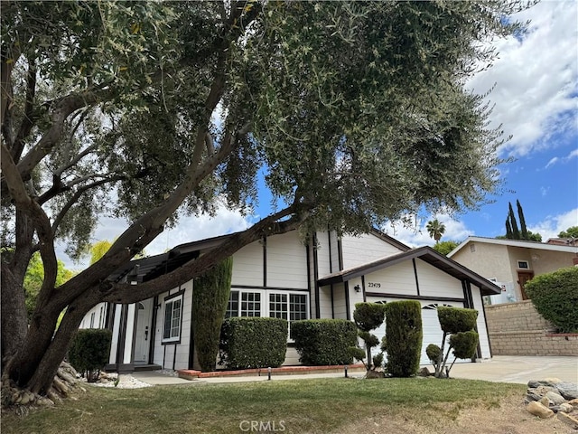 view of front of property with a garage, driveway, and fence