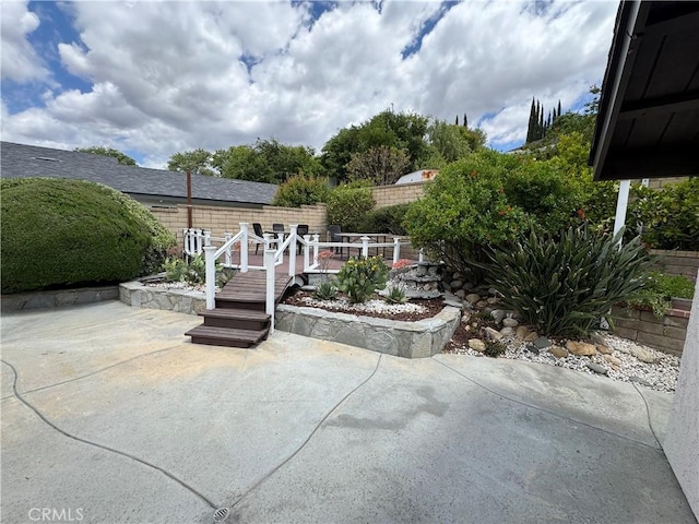 view of patio featuring fence