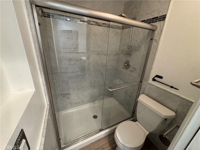 full bath with toilet and a shower stall