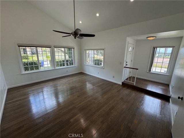 unfurnished living room featuring plenty of natural light, baseboards, high vaulted ceiling, and recessed lighting