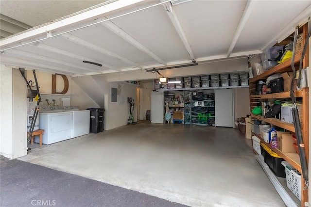 garage with washer and dryer and electric panel