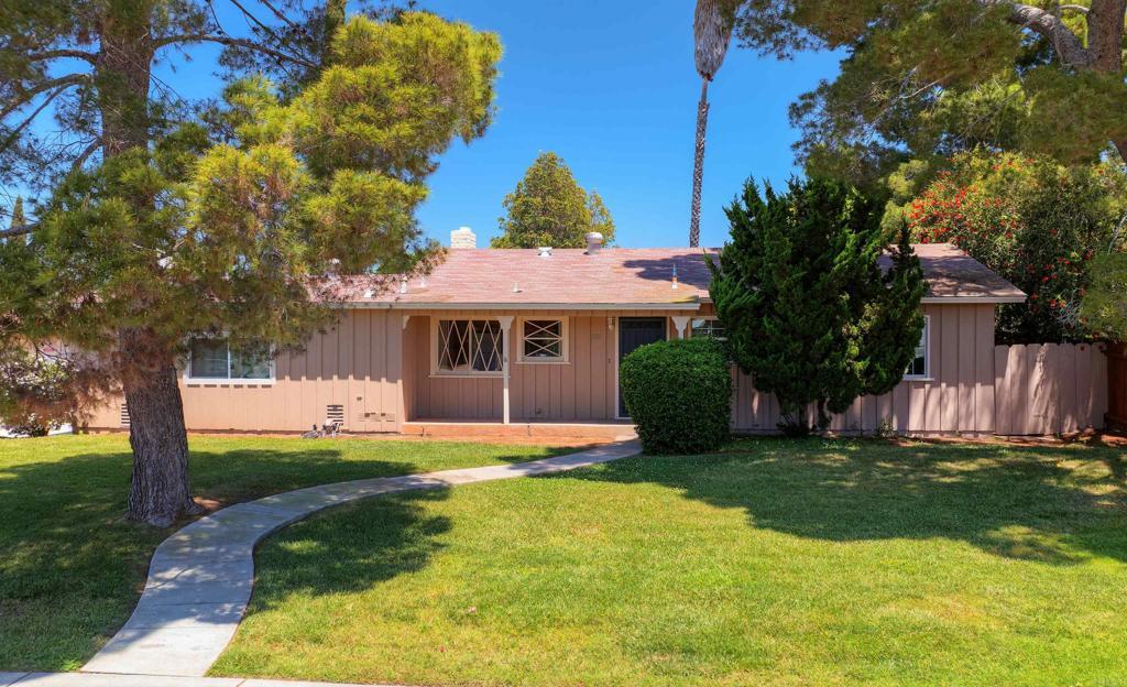 1130 S Tulip St, Escondido, CA 92025 - view of front facade featuring a front lawn, board and batten siding, and a chimney