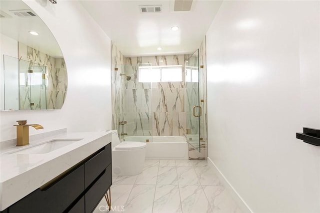 full bathroom featuring bath / shower combo with glass door, toilet, baseboards, vanity, and marble finish floors