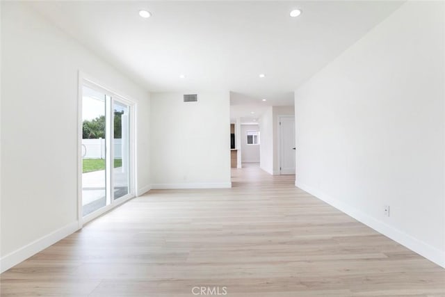 empty room with light wood-style flooring, baseboards, and recessed lighting