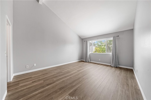 206 Eisenhower, Placentia, CA 92870 - empty room featuring wood finished floors, lofted ceiling, and baseboards