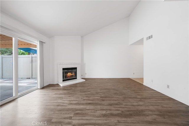 206 Eisenhower, Placentia, CA 92870 - unfurnished living room with wood finished floors, a brick fireplace, and vaulted ceiling
