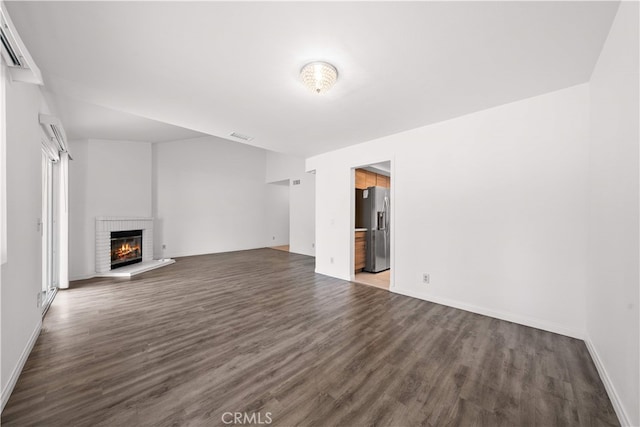 206 Eisenhower, Placentia, CA 92870 - unfurnished living room featuring wood finished floors, a fireplace, and baseboards