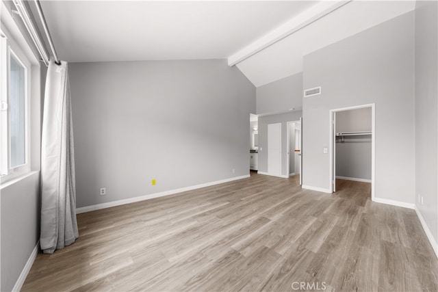 206 Eisenhower, Placentia, CA 92870 - unfurnished bedroom with beam ceiling, light wood-style flooring, baseboards, a walk in closet, and high vaulted ceiling