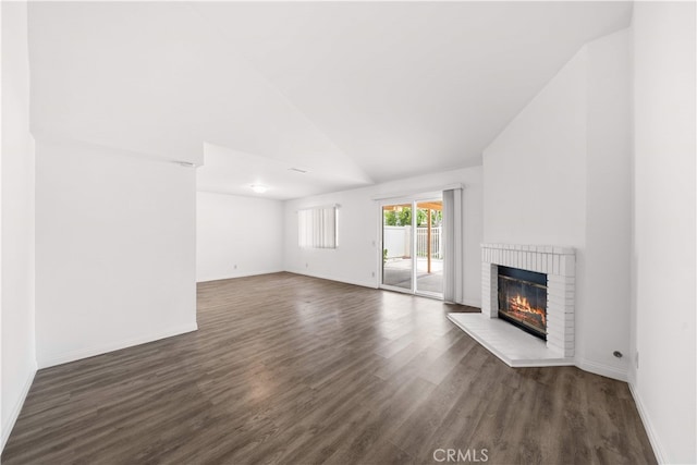 206 Eisenhower, Placentia, CA 92870 - unfurnished living room featuring a fireplace, vaulted ceiling, wood finished floors, and baseboards