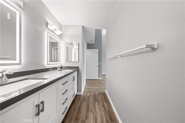 206 Eisenhower, Placentia, CA 92870 - bathroom featuring wood finished floors, baseboards, and double vanity
