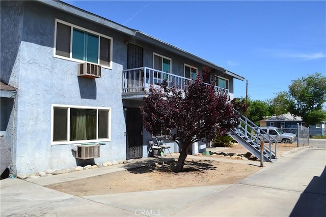 308 W Kildare St, Lancaster, CA 93534 - view of building exterior with central air condition unit, stairs, and a wall mounted AC
