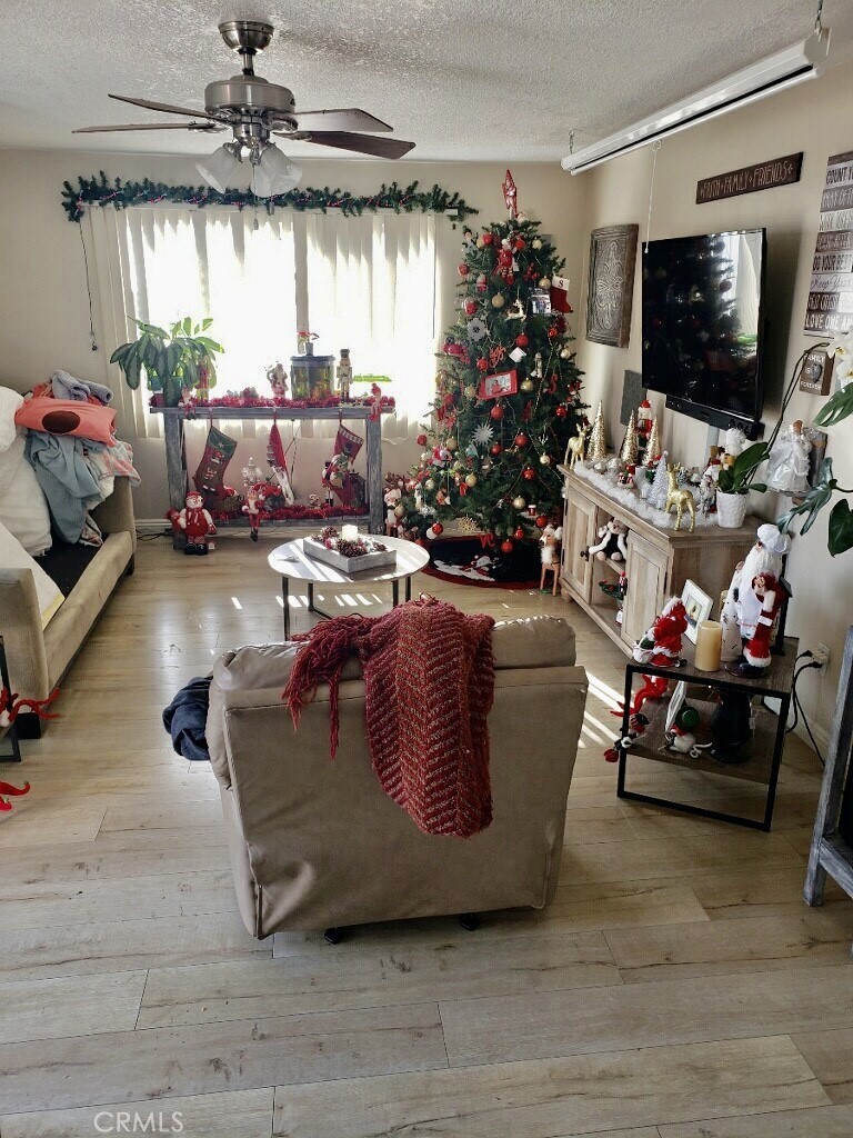 122 Avenida Pelayo, San Clemente, CA 92672 - living room with a textured ceiling, ceiling fan, and hardwood / wood-style flooring