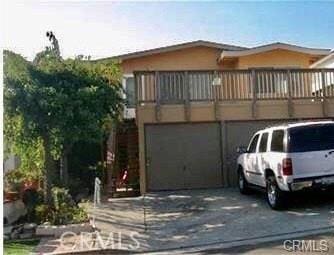 122 Avenida Pelayo, San Clemente, CA 92672 - view of front facade featuring driveway, a garage, and a balcony