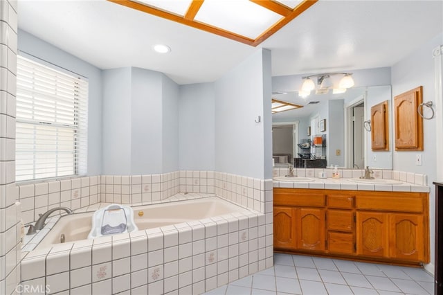 full bath featuring a garden tub, tile patterned floors, and double vanity