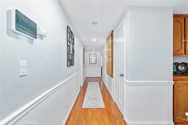 corridor with light wood-style flooring and recessed lighting