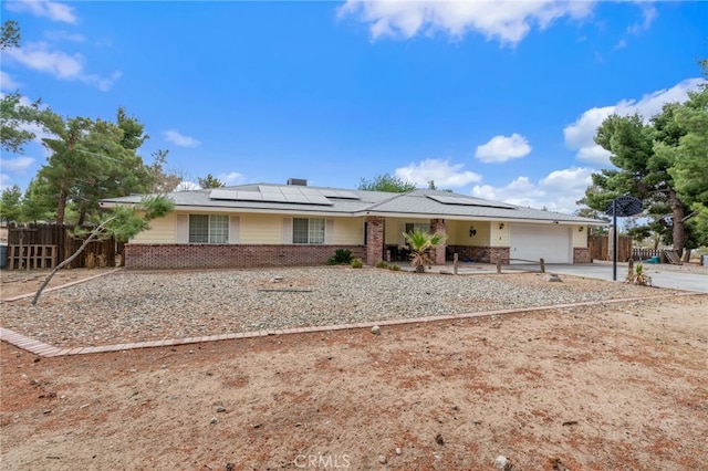 ranch-style house with brick siding, fence, an attached garage, and concrete driveway