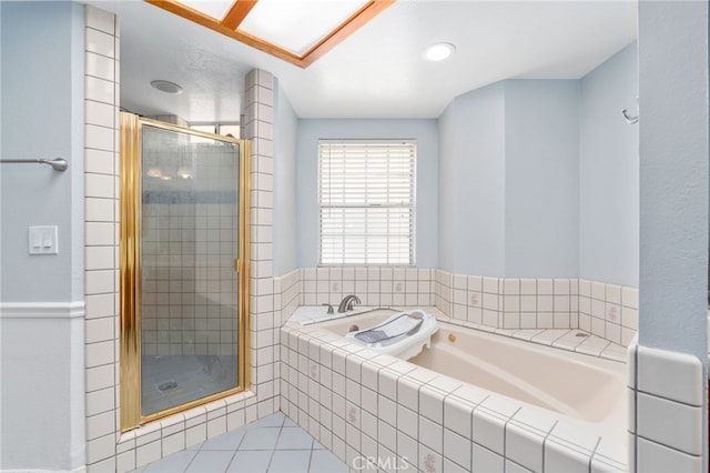 full bathroom featuring a shower stall, tile patterned floors, and a garden tub