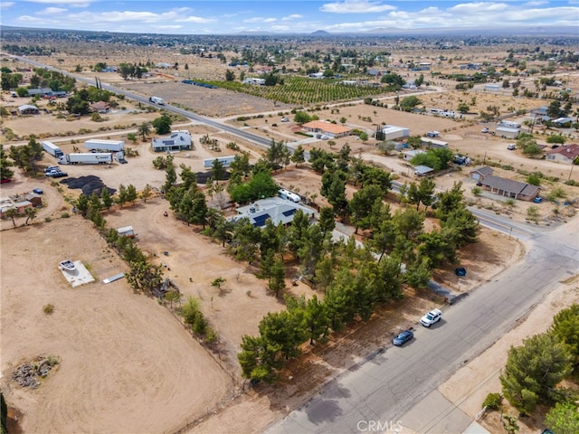 aerial view of sparsely populated area featuring a mountain backdrop and a desert landscape