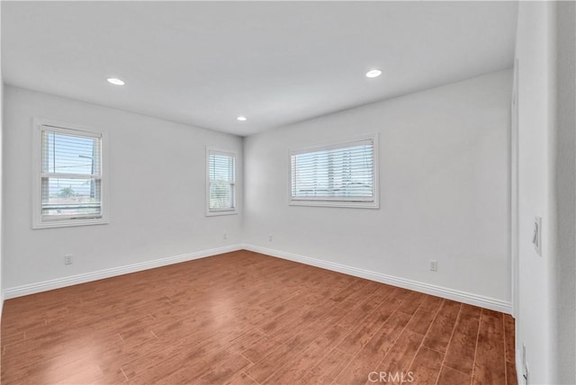 9588 Shimizu River Cir, Fountain Valley, CA 92708 - empty room featuring healthy amount of natural light, wood finished floors, baseboards, and recessed lighting