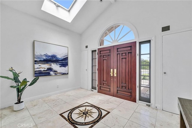9588 Shimizu River Cir, Fountain Valley, CA 92708 - foyer entrance featuring high vaulted ceiling, a skylight, baseboards, and light tile patterned floors