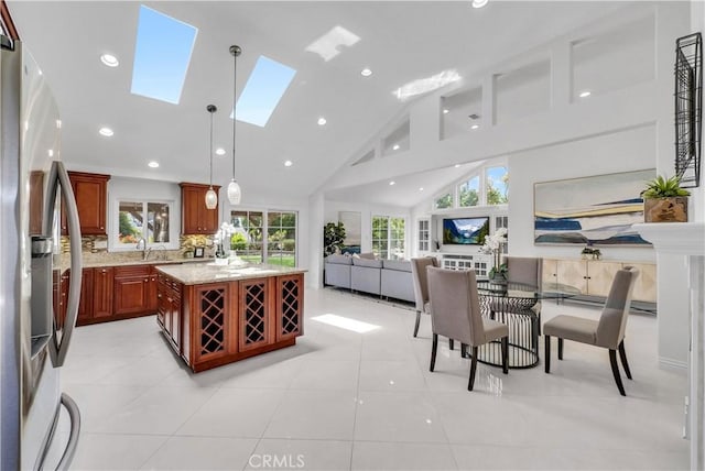 9588 Shimizu River Cir, Fountain Valley, CA 92708 - dining room featuring plenty of natural light, a skylight, recessed lighting, high vaulted ceiling, and light tile patterned floors