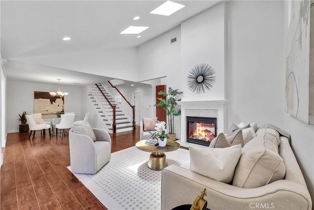 9588 Shimizu River Cir, Fountain Valley, CA 92708 - living area featuring stairway, a fireplace, lofted ceiling, a chandelier, and wood finished floors