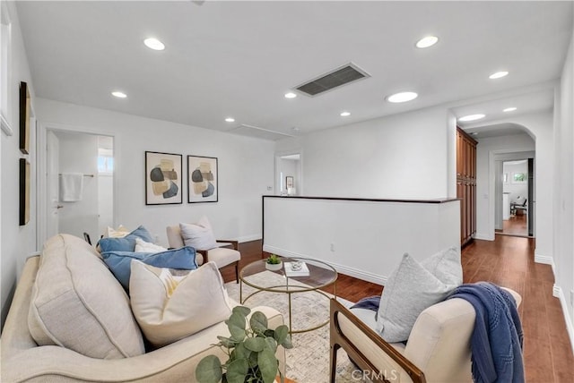 9588 Shimizu River Cir, Fountain Valley, CA 92708 - living room featuring dark wood-type flooring, arched walkways, baseboards, and recessed lighting