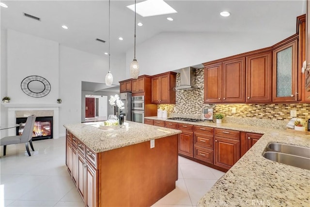 9588 Shimizu River Cir, Fountain Valley, CA 92708 - kitchen with wall chimney exhaust hood, a skylight, a sink, stainless steel appliances, and light tile patterned flooring