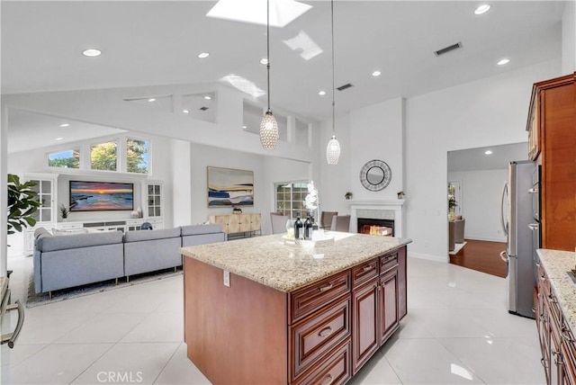 9588 Shimizu River Cir, Fountain Valley, CA 92708 - kitchen featuring open floor plan, a premium fireplace, light tile patterned floors, healthy amount of natural light, and high vaulted ceiling