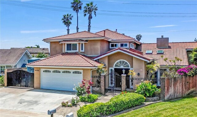 9588 Shimizu River Cir, Fountain Valley, CA 92708 - mediterranean / spanish-style home featuring stucco siding, a gate, a tile roof, concrete driveway, and a garage