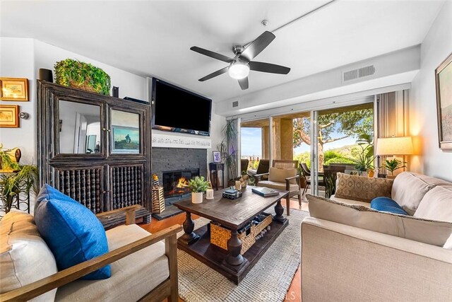 11165 Affinity Ct Unit 32, San Diego, CA 92131 - living room featuring ceiling fan, a glass covered fireplace, and wood finished floors