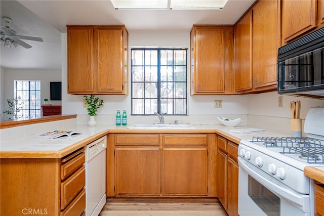 8541 San Clemente Dr, Rancho Cucamonga, CA 91730 - kitchen featuring white appliances, a sink, a ceiling fan, a peninsula, and brown cabinetry